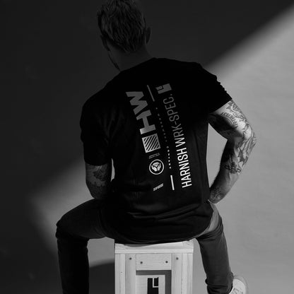 Person wearing a black t-shirt with 'Harnish' branding, sitting on a white crate with 'Harnish' logo.
